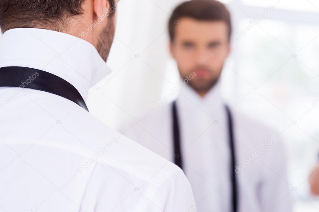 Man in white shirt and untied necktie