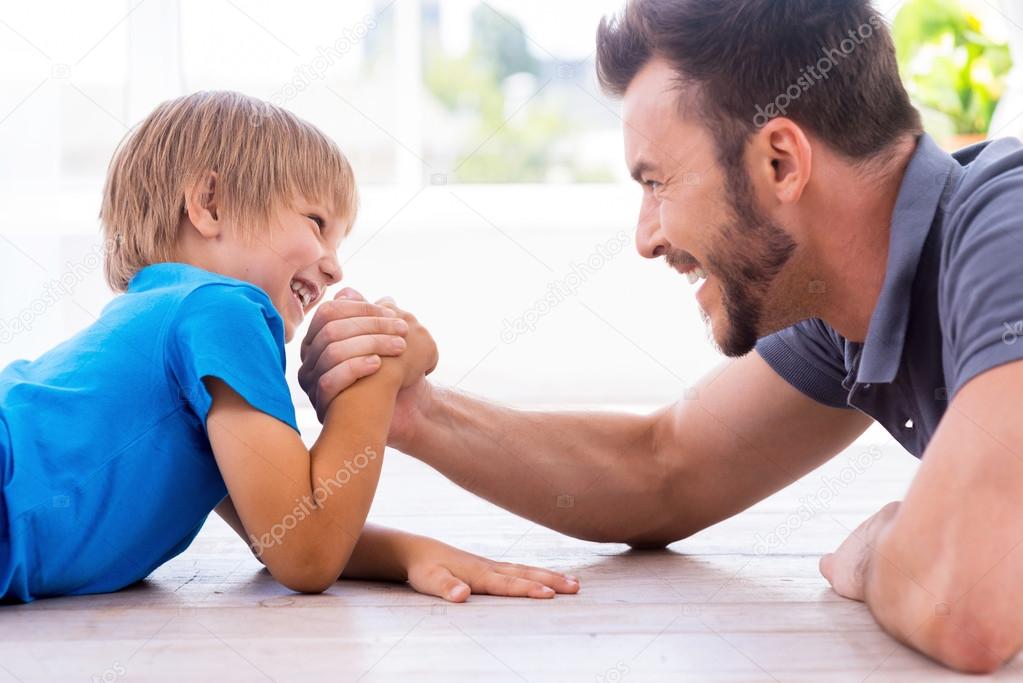 Father and son competing in arm wrestling