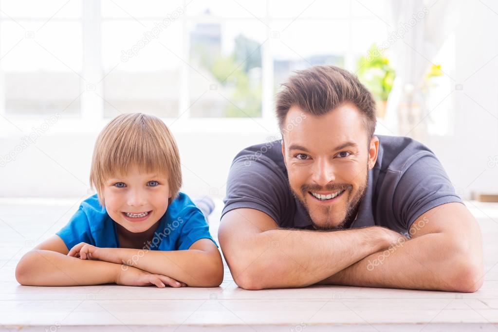 Father and son lying on the floor