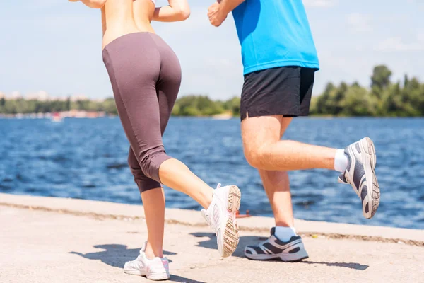 Woman and man jogging together.