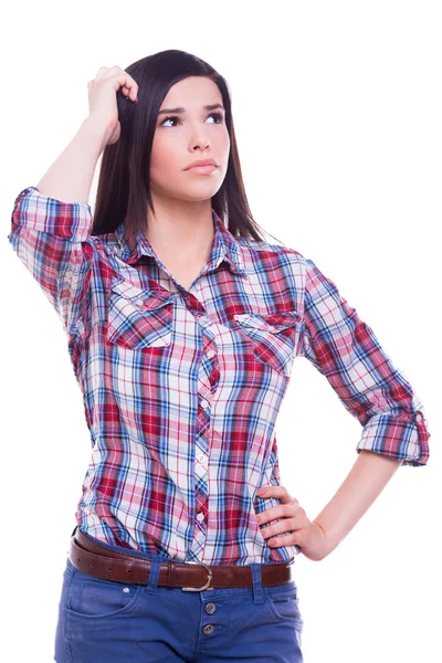 Thoughtful beauty. Thoughtful young woman holding hand on in hair and looking away while standing isolated on white — Stock Photo, Image