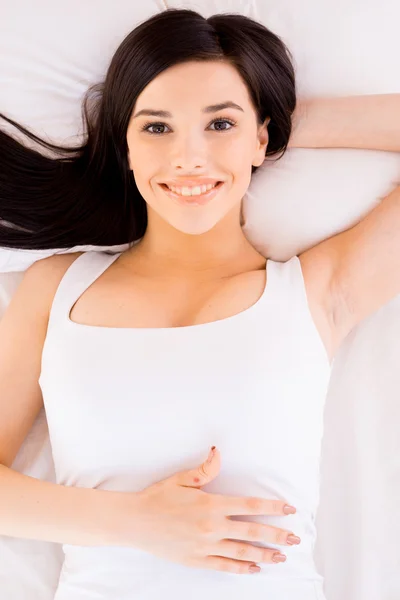 Woman relaxing in bed. Royalty Free Stock Photos