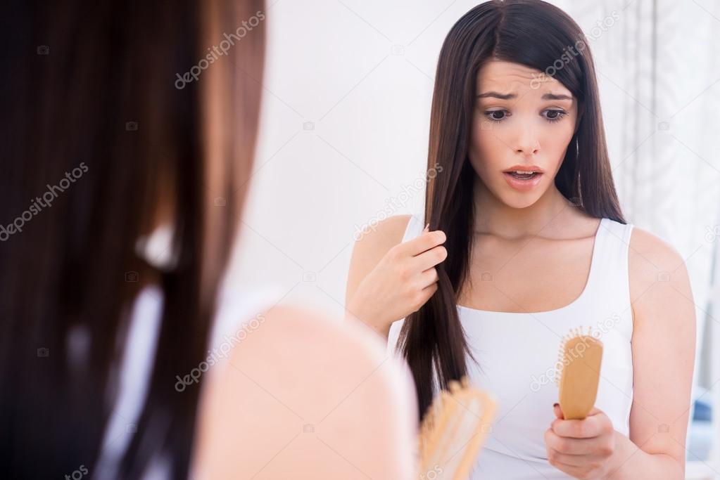 Woman looking at her hairbrush
