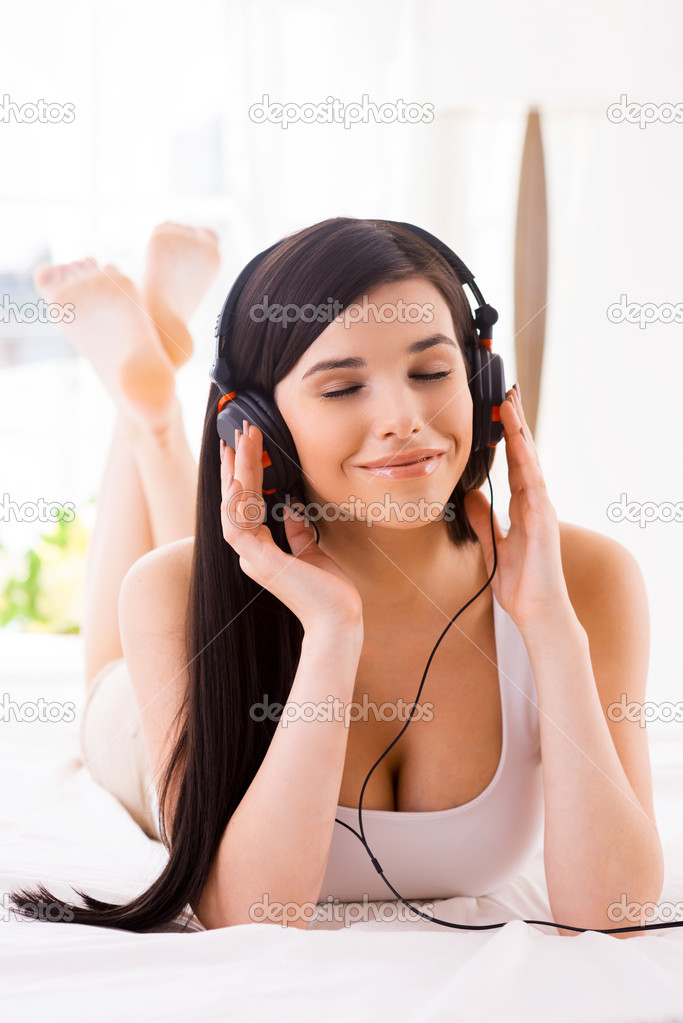 Woman adjusting her headphones
