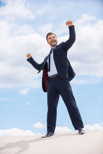 Man in formal wear keeping his arms raised — Stock Photo, Image