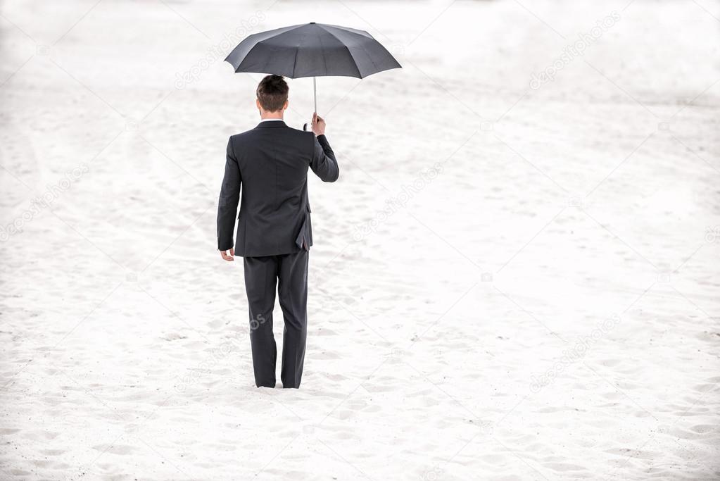 An in formal wear holding umbrella