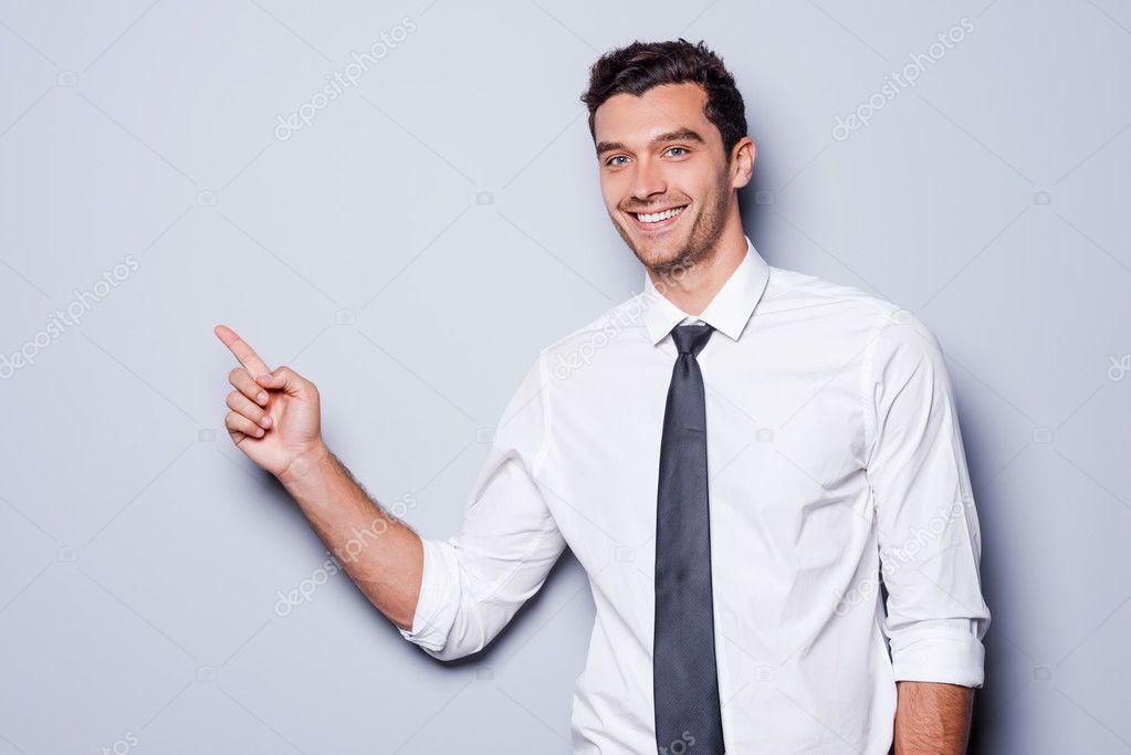Businessman pointing copy space.