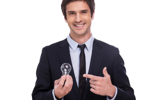 Man in formalwear holding light bulb and pointing it — Stock Photo, Image