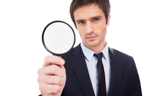 Man in formalwear holding magnifying glass — Stock Photo, Image