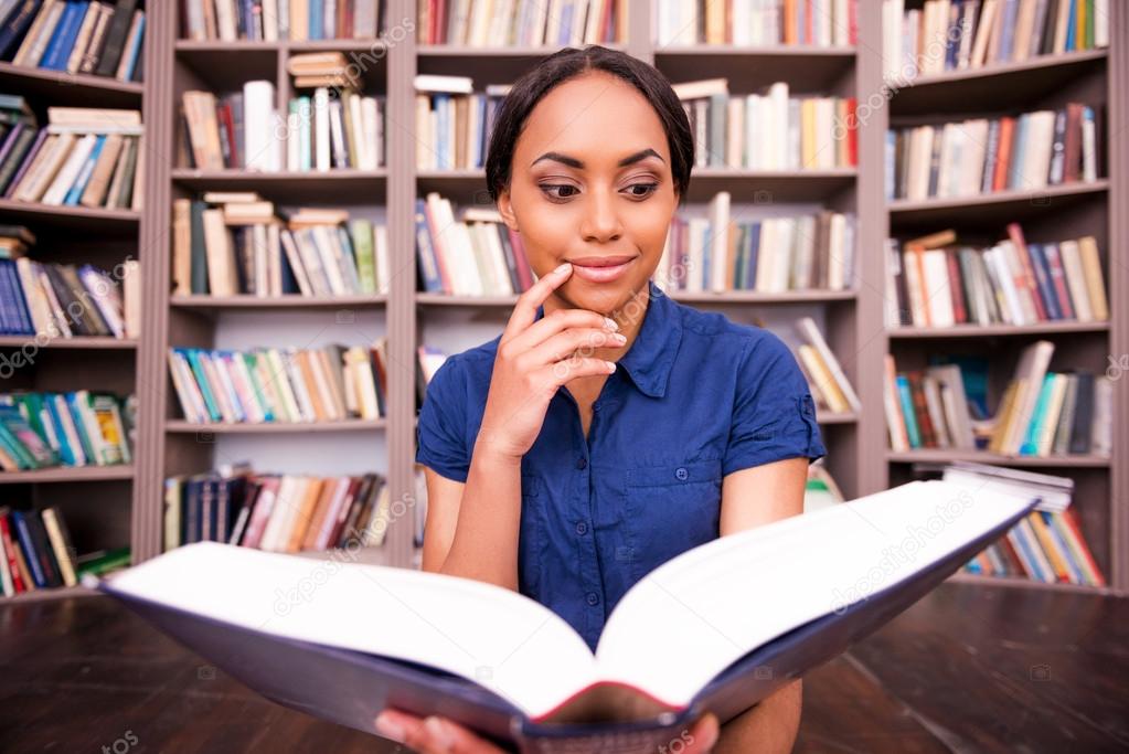African female student reading book