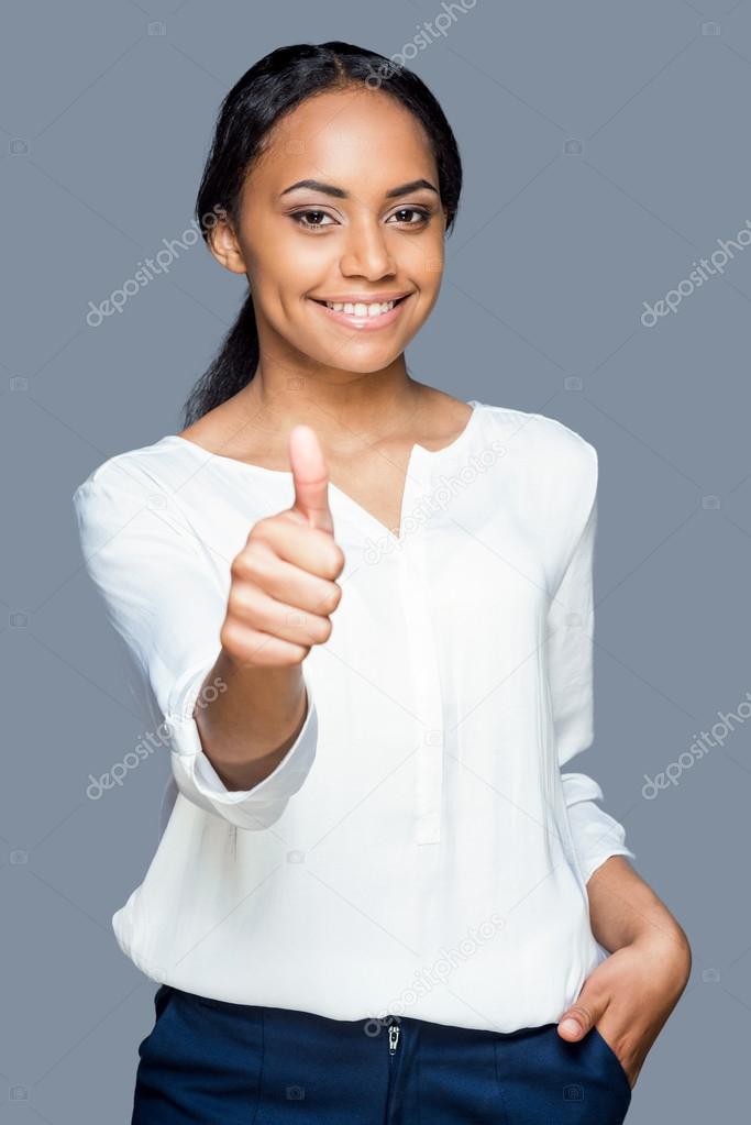 African woman showing her thumb up