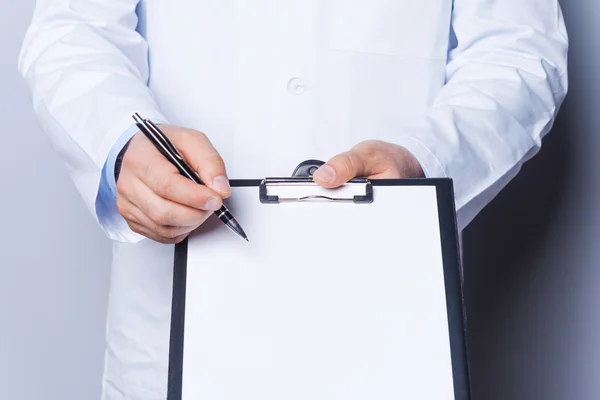 Doctor pointing copy space on clipboard — Stock Photo, Image