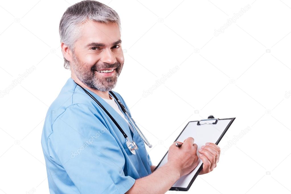 Doctor writing something at his clipboard