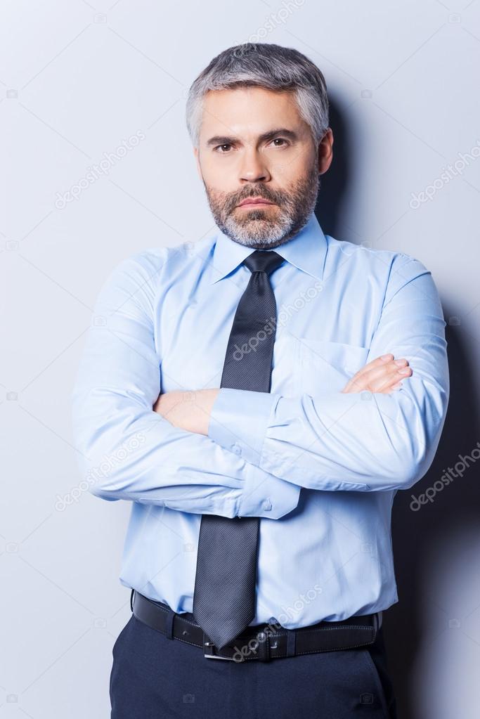 Confident mature man in shirt and tie