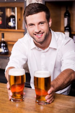 Bartender holding glasses with beer clipart