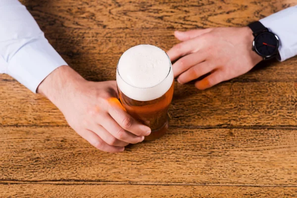 Mãos segurando copo de cerveja — Fotografia de Stock