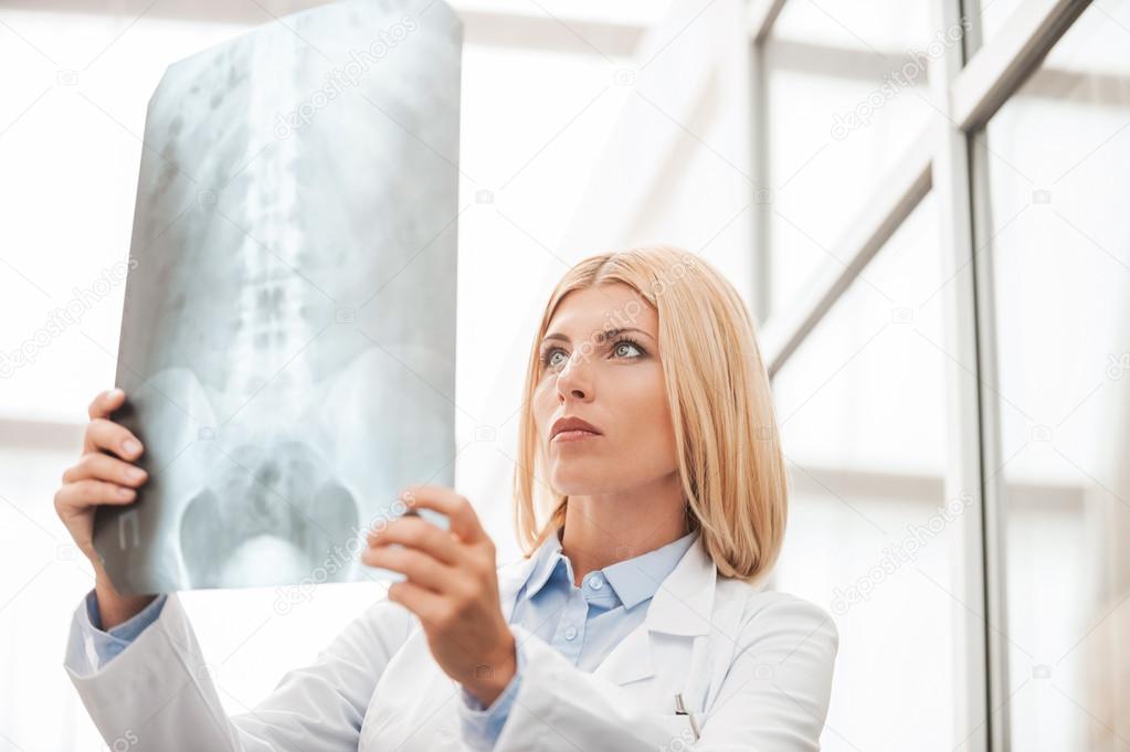 Female doctor examining X-ray.