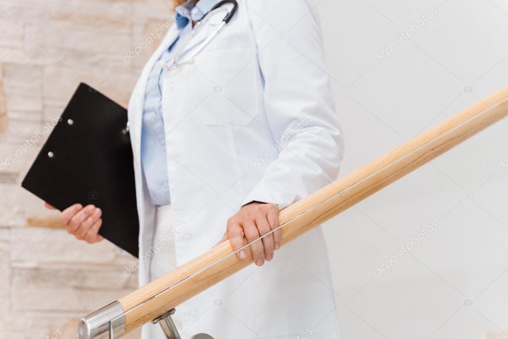 Female doctor moving downstairs