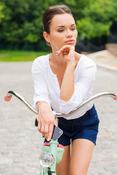 Woman drinking coffee and walking with bicycle — Stock Photo, Image