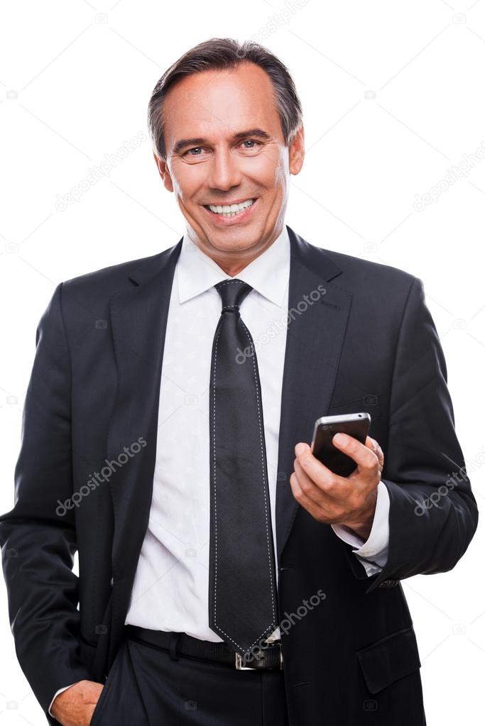 Confident businessman man holding mobile phone