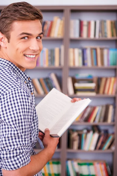 Happy young man holding book — Stock Photo, Image