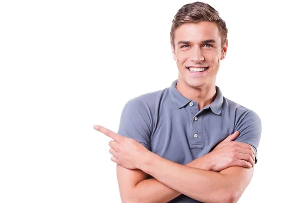 Handsome young man pointing away — Stock Photo, Image