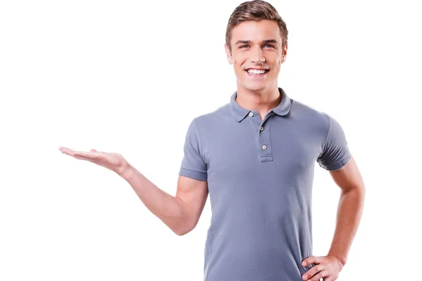 Handsome young man holding copy space — Stock Photo, Image