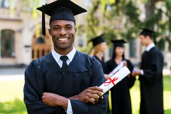 Happy African man in graduation gown — Stock Photo, Image