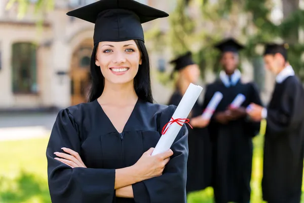 Young woman in graduation gown — Stock Photo, Image
