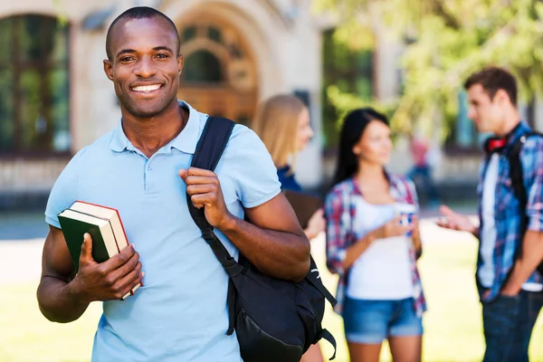 Young African man holding books