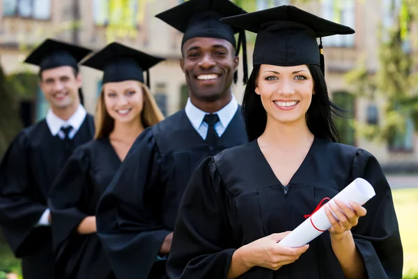 College graduates standing in row — Stock Photo, Image