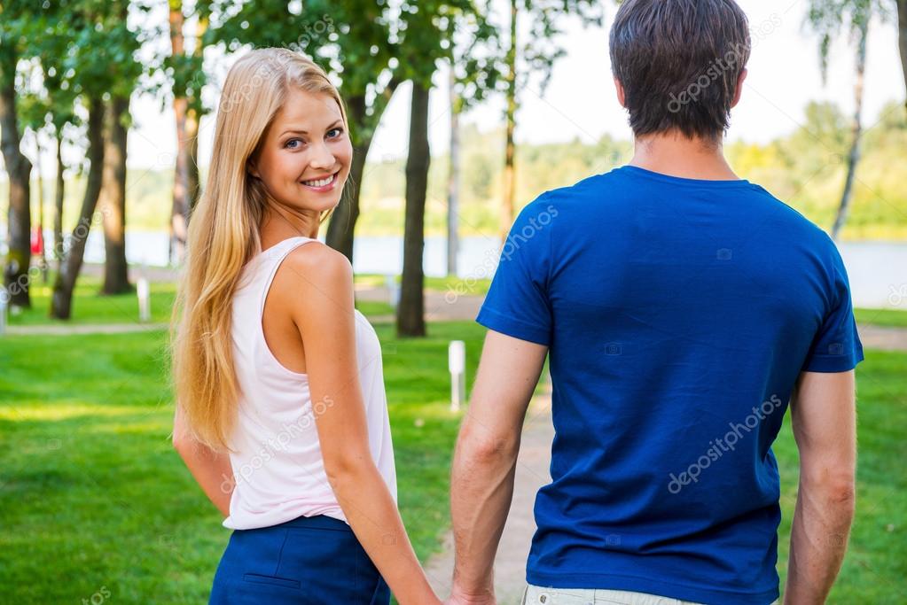 Woman looking over shoulder and walking with boyfriend