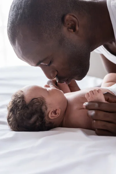 African man playing with his little baby Stock Picture