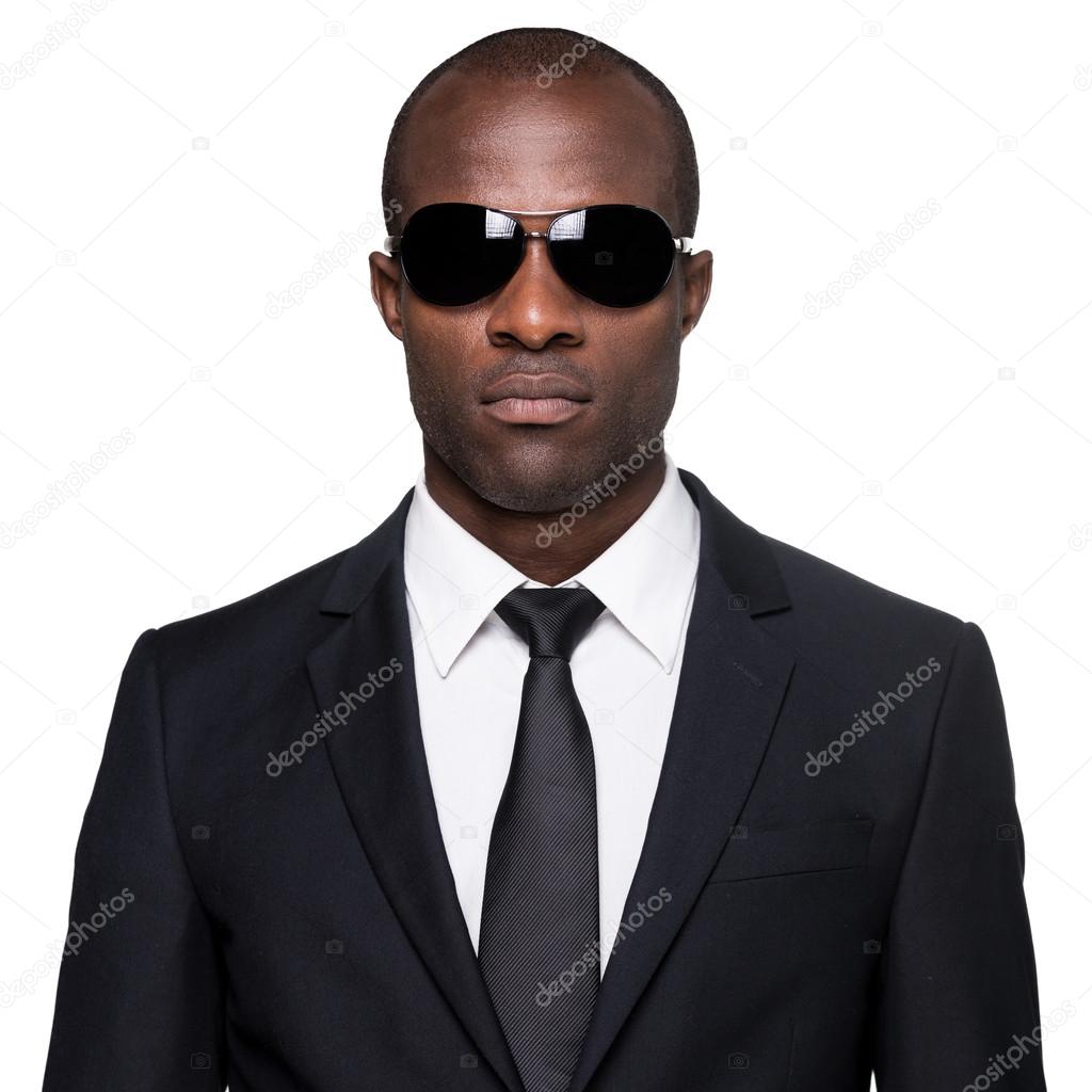 African man in formalwear and sunglasses