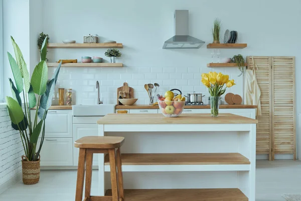 Cozy modern interior of kitchen interior with white furniture and bright elements