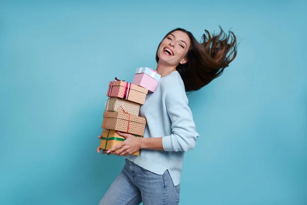 Happy Young Woman Carrying Many Gift Boxes While Standing Blue — Stock Photo, Image