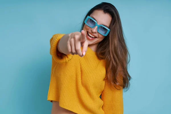 Cheerful Young Woman Pointing Camera Smiling While Standing Blue Background — Stock Photo, Image