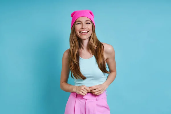 Cheerful Young Woman Pink Hat Smiling While Standing Blue Background — Stock Photo, Image