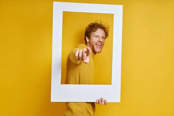 Playful Man Looking Picture Frame Gesturing While Standing Yellow Background — Stock Photo, Image