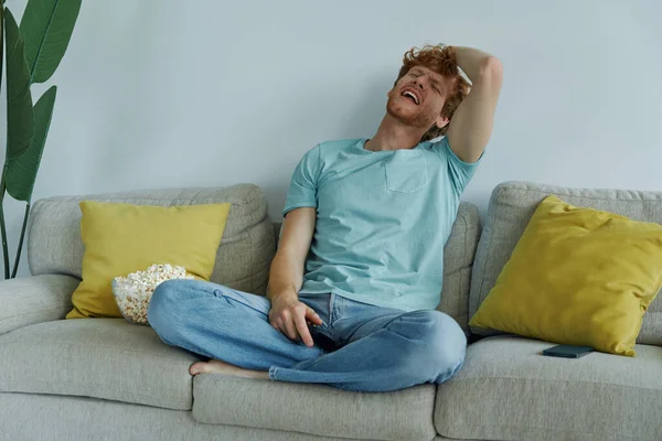 Young Redhead Man Looking Upset While Playing Video Games Couch — Stockfoto