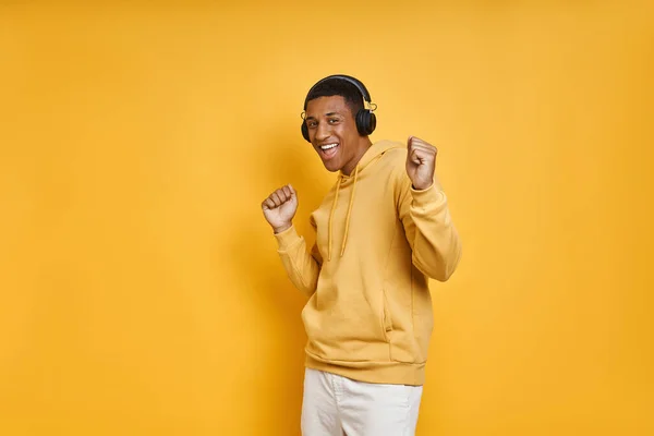 Happy African Man Headphones Enjoying Music While Standing Yellow Background — Stockfoto