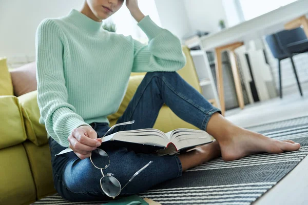 Close Tired Woman Holding Book While Sitting Floor Home — Stockfoto