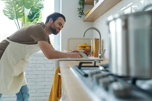 Bored Young Man Washing Dishes Domestic Kitchen — Foto de Stock