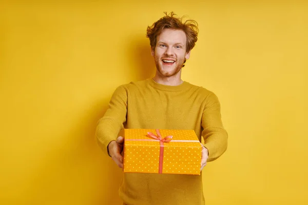 Happy Redhead Man Stretching Out Gift Box While Standing Yellow — Photo