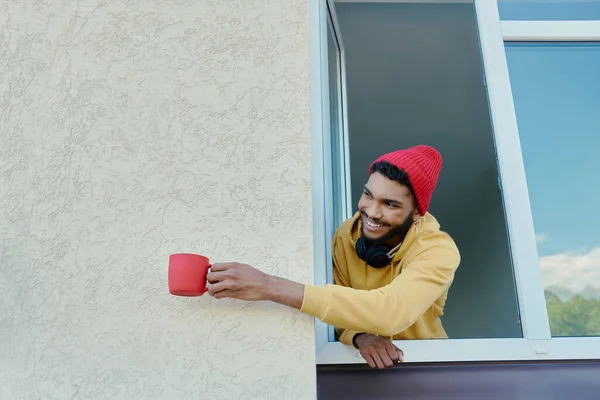 Shot Happy African Man Looking Out Window Holding Cup — Stok fotoğraf