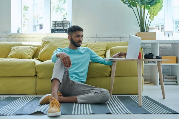 Relaxed African Man Using Laptop While Sitting Floor Home — Foto Stock