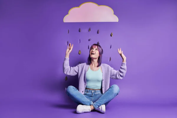Surprised Young Woman Sitting Paper Cloud Smiling Purple Background — 스톡 사진