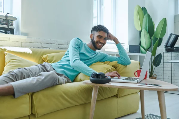Handsome African Man Using Laptop While Relaxing Couch Home — Stockfoto