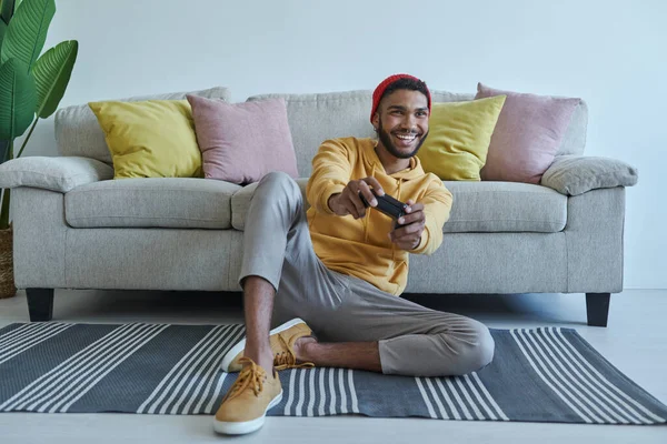 Excited Young African Man Playing Video Games While Sitting Floor — Fotografia de Stock