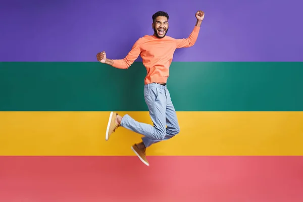 Full Length Excited African Man Jumping Colorful Background —  Fotos de Stock